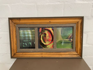A set of three framed artworks depicting a nature-inspired design, housed in a brown wooden frame.