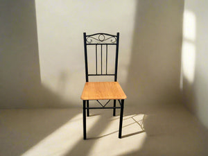 A Pine Seat Dining Chair with a black metal frame and a natural wood seat positioned against a white brick wall.