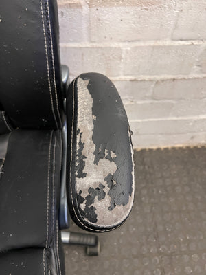 Black Padded Office Armchair on Wheels (Peeling Pleather)