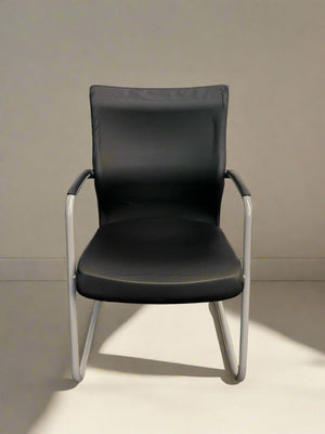 A black and grey boardroom chair with an ergonomic design, featuring a grey frame and black seat and backrest.
