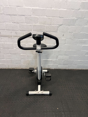 Compact White Exercise Bike with Minor Wear โ Perfect for Home Workouts