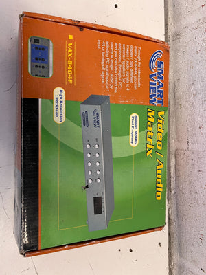 Box of a video/audio matrix switcher with branding on a concrete floor.