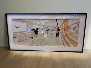 Framed picture of a modern office space with 'vivo' branding.