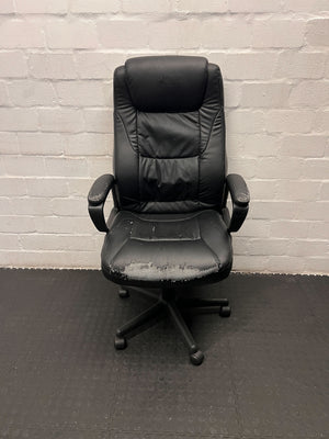 Black office chair against a gray brick wall.
