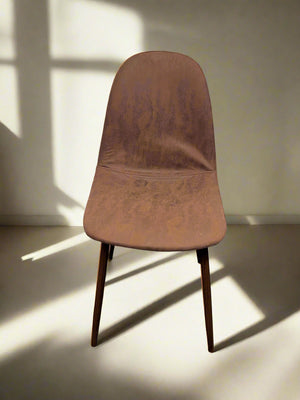 A vintage brown dining chair with mid-century design, featuring a faux leather seat and wooden legs.