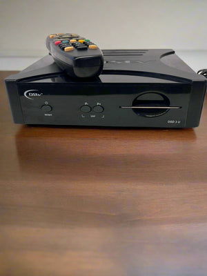 Black electronic device with remote control on a white surface