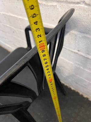 Durable Black Plastic Chair with Minor Scratches