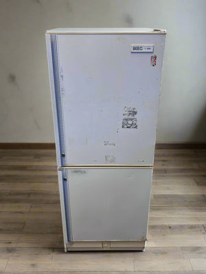 Refrigerator with brand logo on a white brick wall background