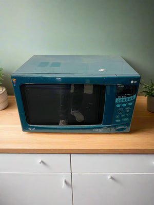 Blue LG microwave on a wooden countertop with a light green wall in the background.