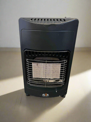 Black gas heater on a concrete floor with a brick wall background