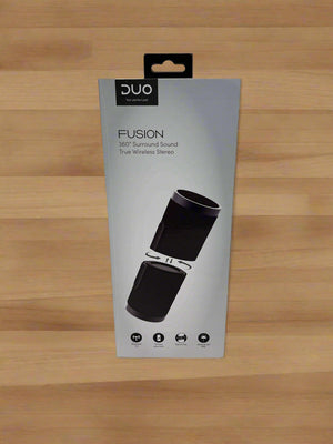 Packaging of DUO Fusion True Wireless Stereo speakers on a concrete surface