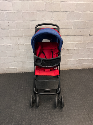 Red and Navy Four-Wheel Stroller with Snack Tray — Fair Condition with Signs of Use
