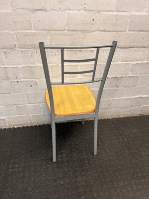 Silver Metal Dining Chair with Wood-Effect Seat — Visible Surface Wear and Scuffing
