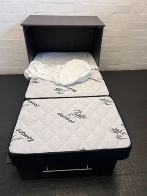 Two mattresses with bamboo branding on a black frame against a white brick wall.