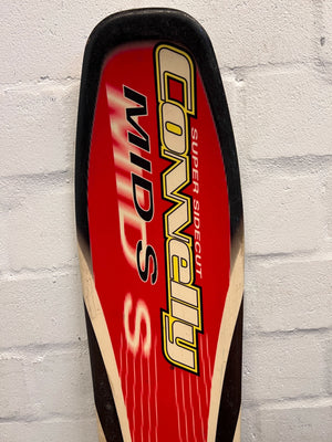 Red and black ski with 'Conway' branding on a gray brick wall background