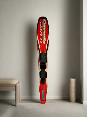 Red and black sports equipment against a white brick wall