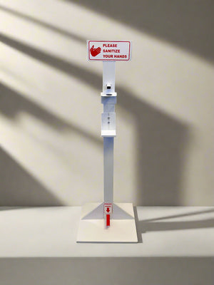 Hand sanitizer station with a sign on a light gray surface.