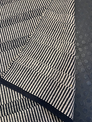 Stylish Black and White Woven Area Rug - Minimalist Design, Slight Wear