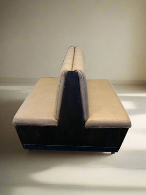 Beige sofa against a white brick wall