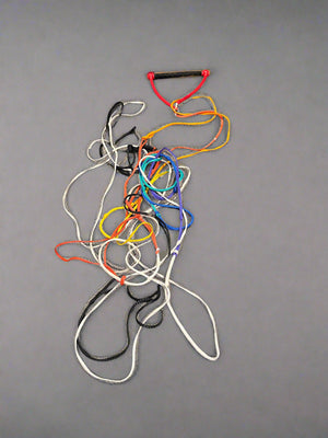 Colorful resistance bands on a black textured floor.