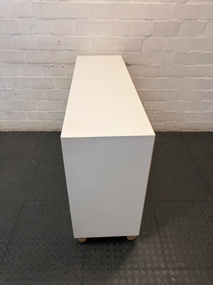 White Storage Cabinet with 4 Drawers and Wood Legs — Small Mark on One Drawer Face