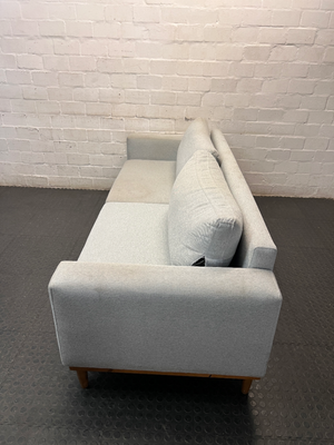 Modern Grey 3 Seater Couch with Tapered Wooden Legs — Small Tear on Cushion – side view