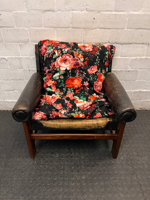 Vintage Brown Leather Armchair with Floral Cushion — Well Used with Significant Leather Wear – main front view