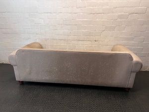 Grey Upholstered Two-Seater Couch with Rolled Arms — Good to Fair Condition with Marks on Armrest – condition detail