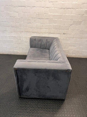 Grey Two Seater Couch with Vertical Stitching — Upholstery Has Wear and Tear – side view