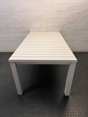Cream Slatted Metal Outdoor Table — Well Used with General Outdoor Wear – back view
