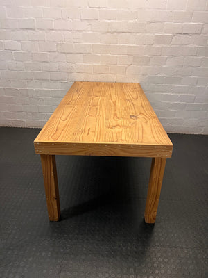 Rustic Oak-Tone Wooden Dining and Work Table — Unfinished Wood with Paint Splatter and Water Rings – side view