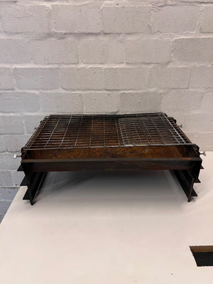 Compact Metal Wood-Burning Braai Stand with Grid — Significant Surface Rust and Heavy Wear – condition detail