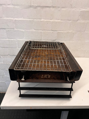 Compact Metal Wood-Burning Braai Stand with Grid — Significant Surface Rust and Heavy Wear – side view