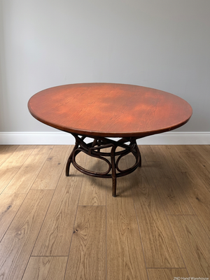 Round Wooden Dining Table with Rattan Style Base — Fair Condition with Visible Wear – styled product image