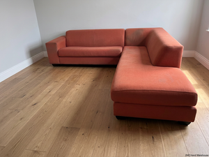 Large Coral Fabric L-Shape Sectional Couch — Visible Wear and Marks – styled product image