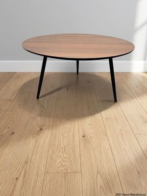 Round Wood-Grain Finish Coffee Table with Tapered Legs – styled product image