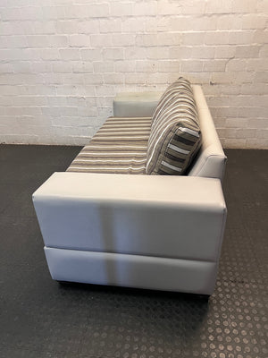 White Two Seater Couch with Striped Fabric Cushions – side view