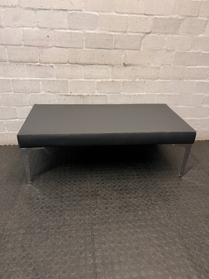 Black Upholstered Bench with Chrome Legs — Fair Condition with Visible Wear