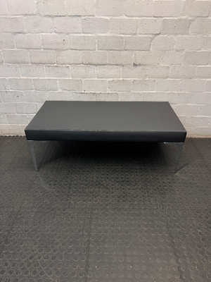 Black Upholstered Bench with Chrome Legs — Fair Condition with Visible Wear