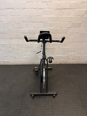 Trojan Spin 120 Exercise Bike in Dark Grey — Good Working Order; Missing Sticker on Wheel
