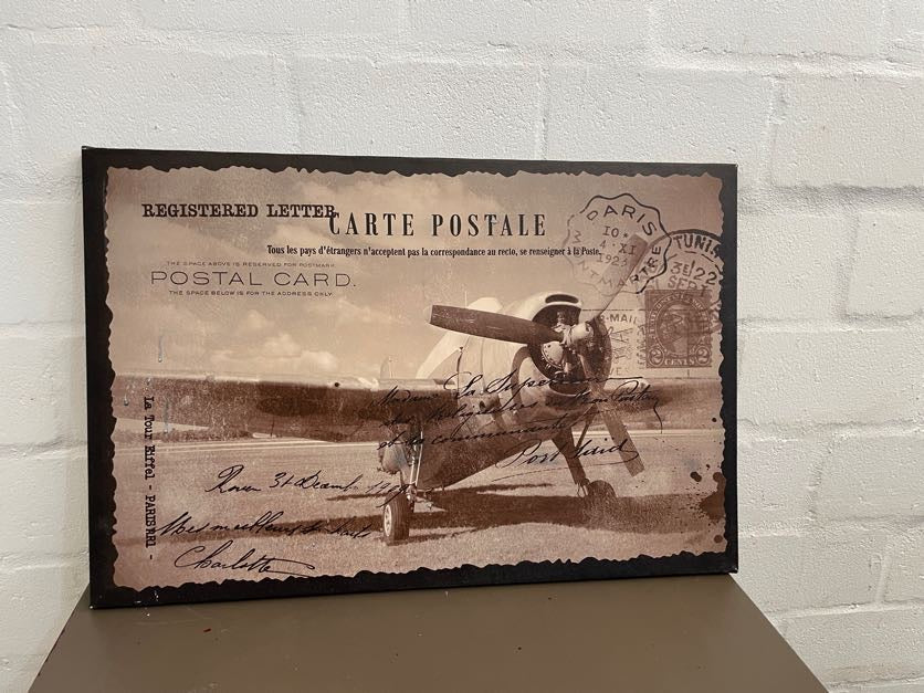 A black and white canvas print featuring a vintage-style airplane design with a postal card motif.