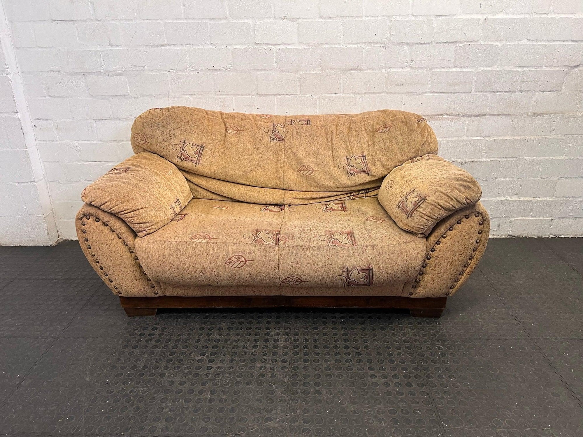 Sandy Brown 2 Seater Couch with Stud and Floral Detailing (Slight Damage Underneath) - REDUCED