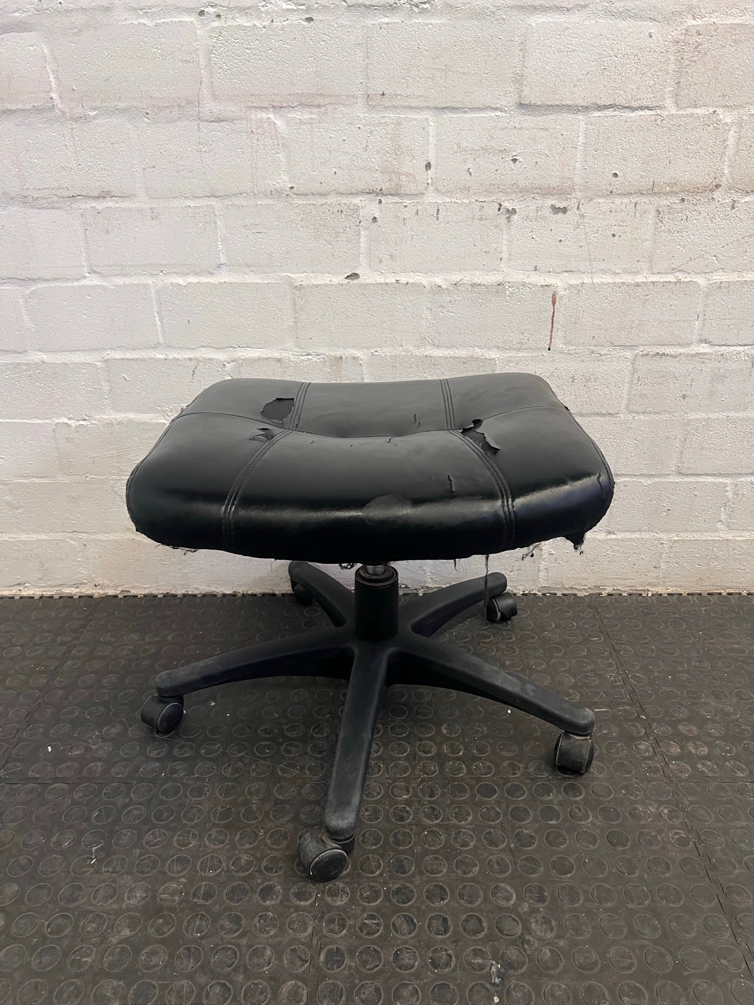 Black Office Footstool on Wheels (Torn Seat)