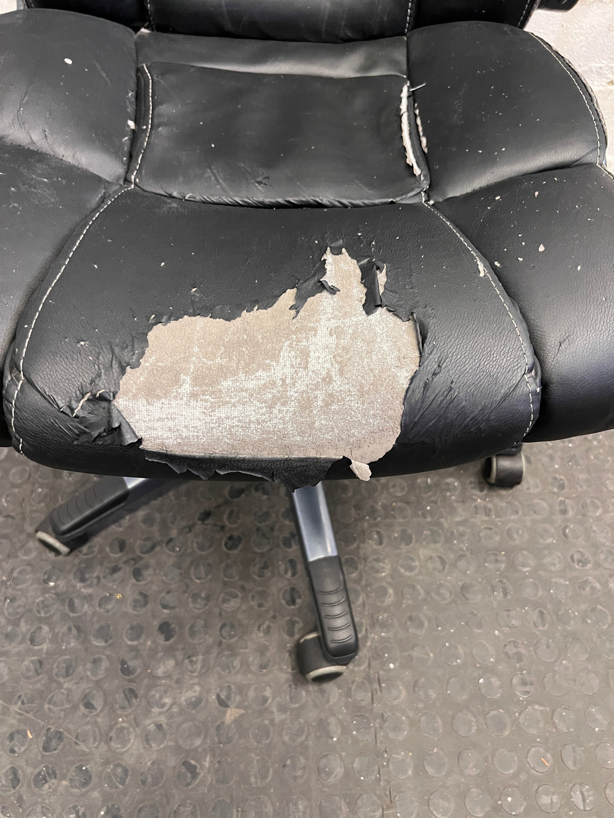 Black Padded Office Armchair on Wheels (Peeling Pleather)