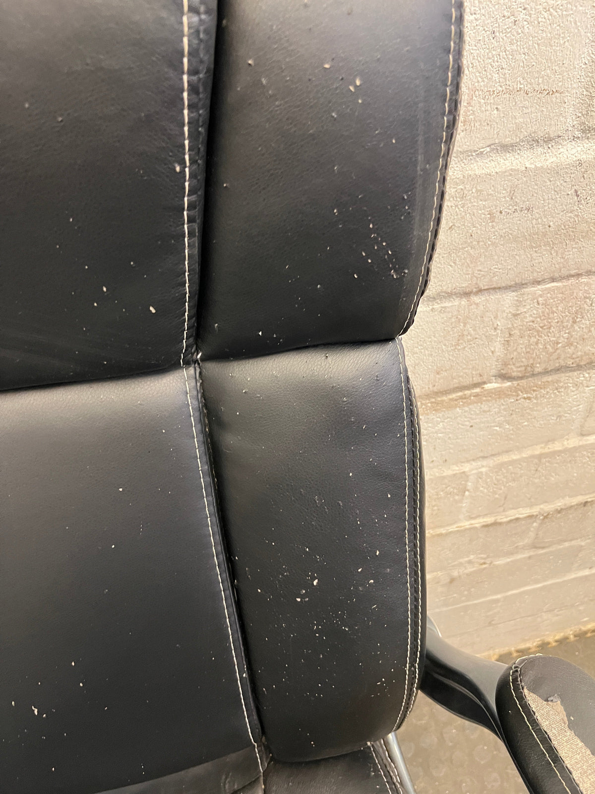 Black Padded Office Armchair on Wheels (Peeling Pleather)