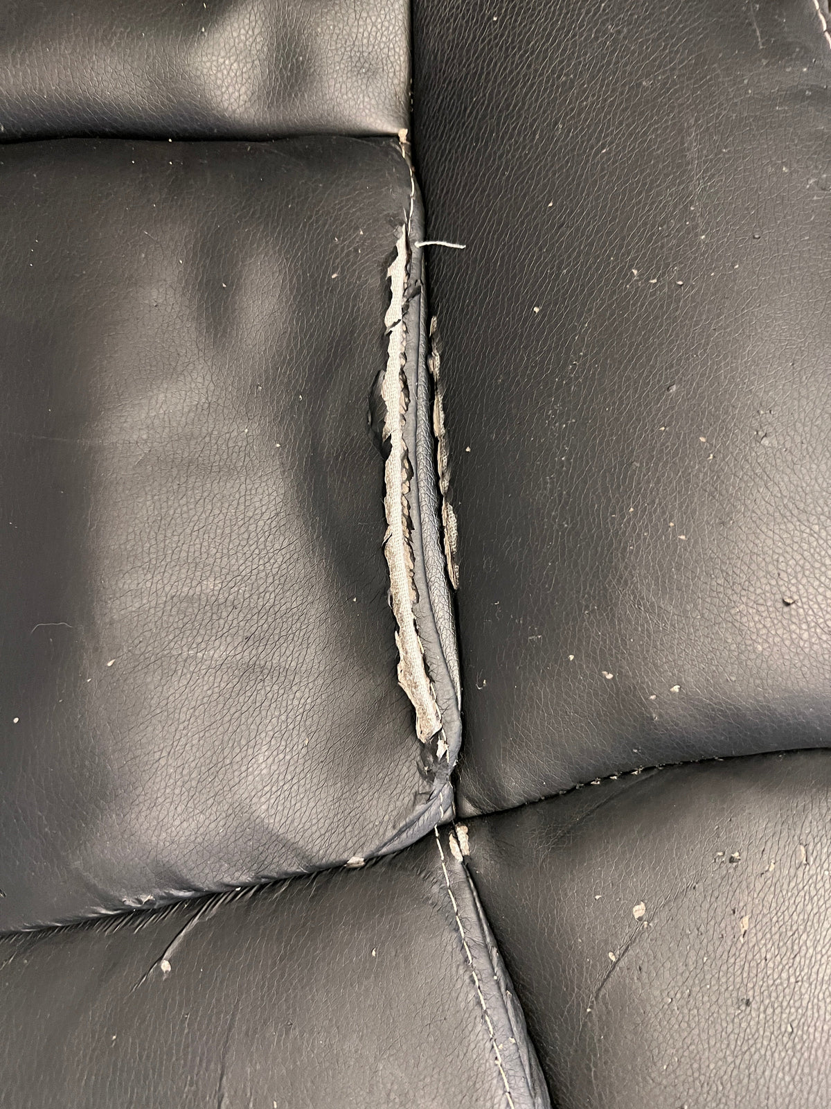 Black Padded Office Armchair on Wheels (Peeling Pleather)