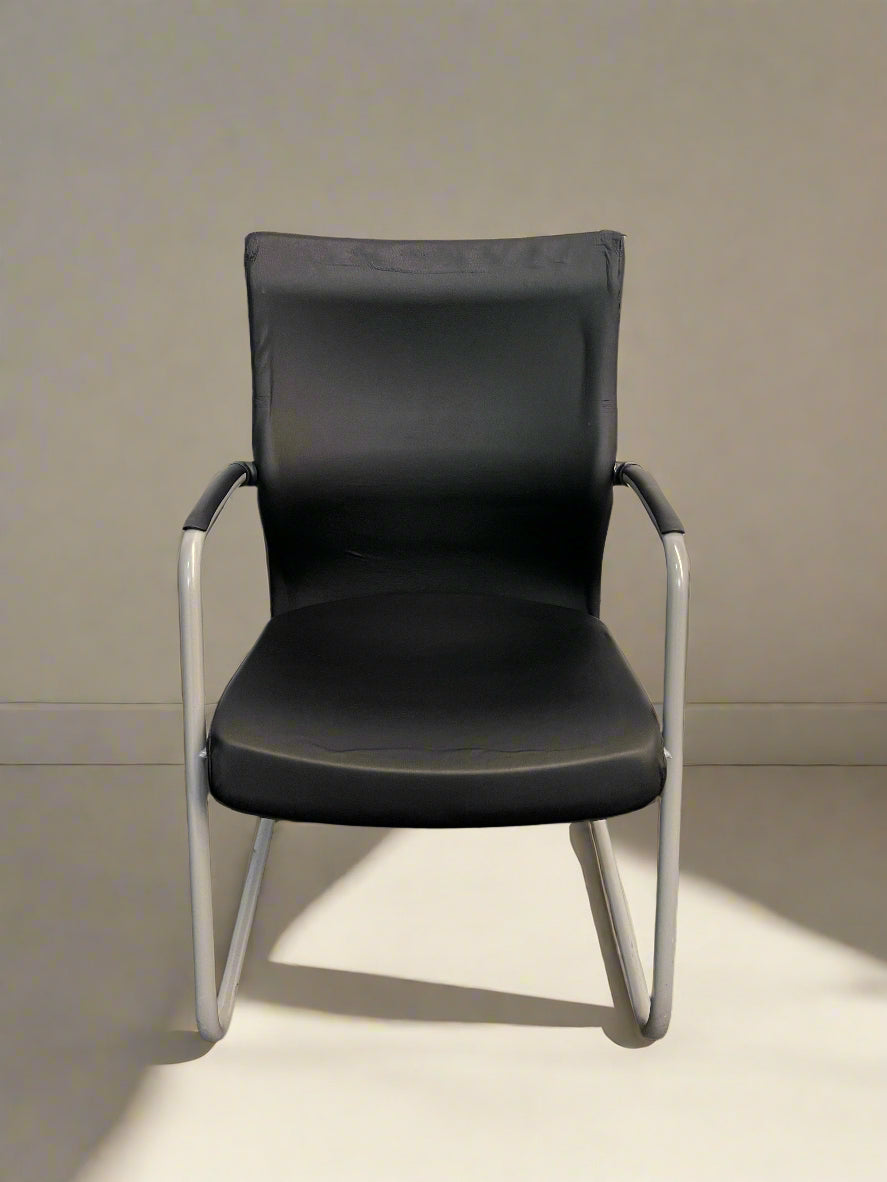 A black and grey boardroom chair with an ergonomic design, featuring a grey frame and black seat and backrest.