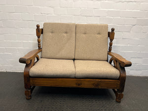 Wooden Framed Two Seater Couch with Tan Pillows