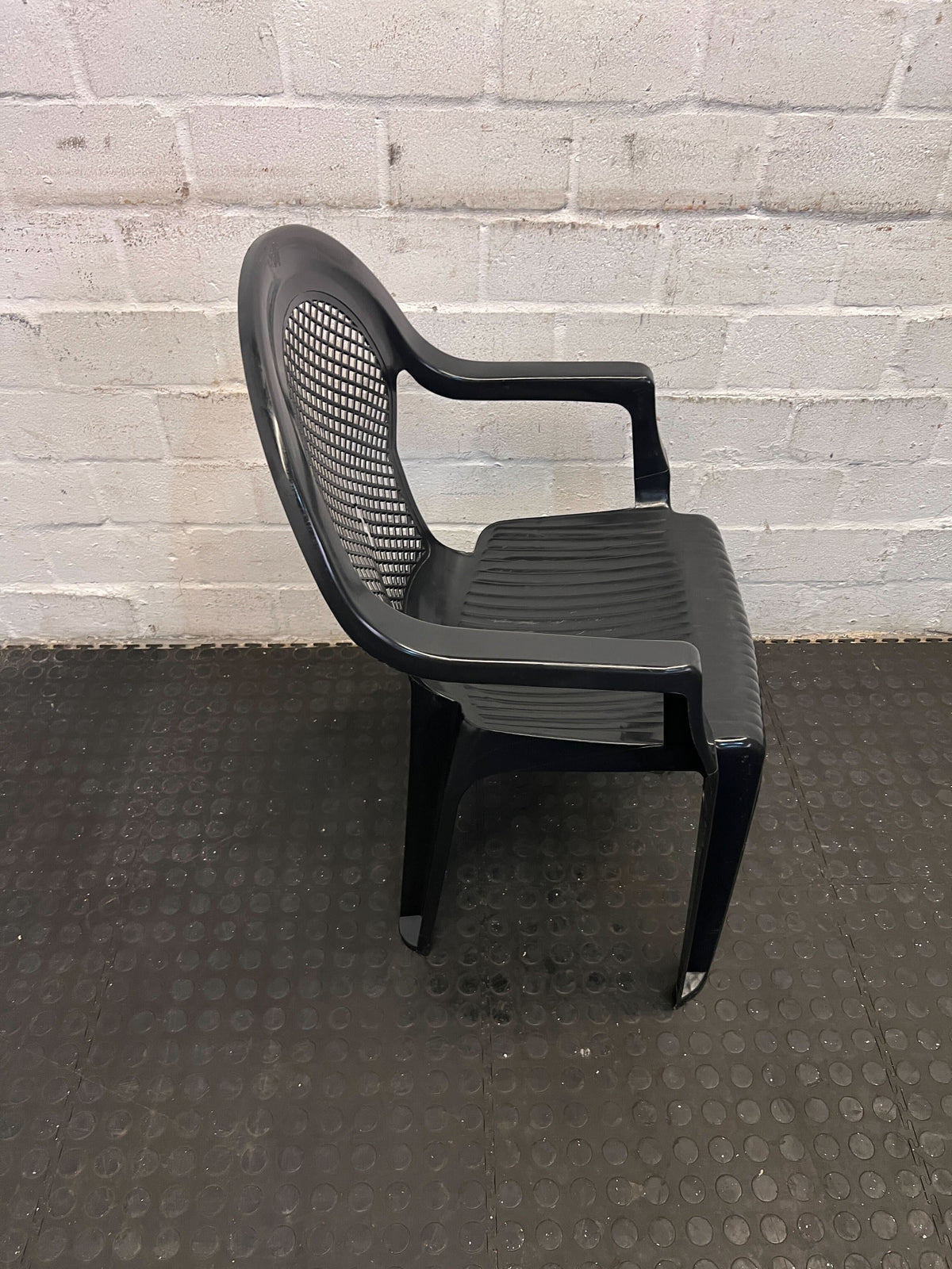 Sturdy Black Plastic Chair with Armrests – Durable & Easy to Clean