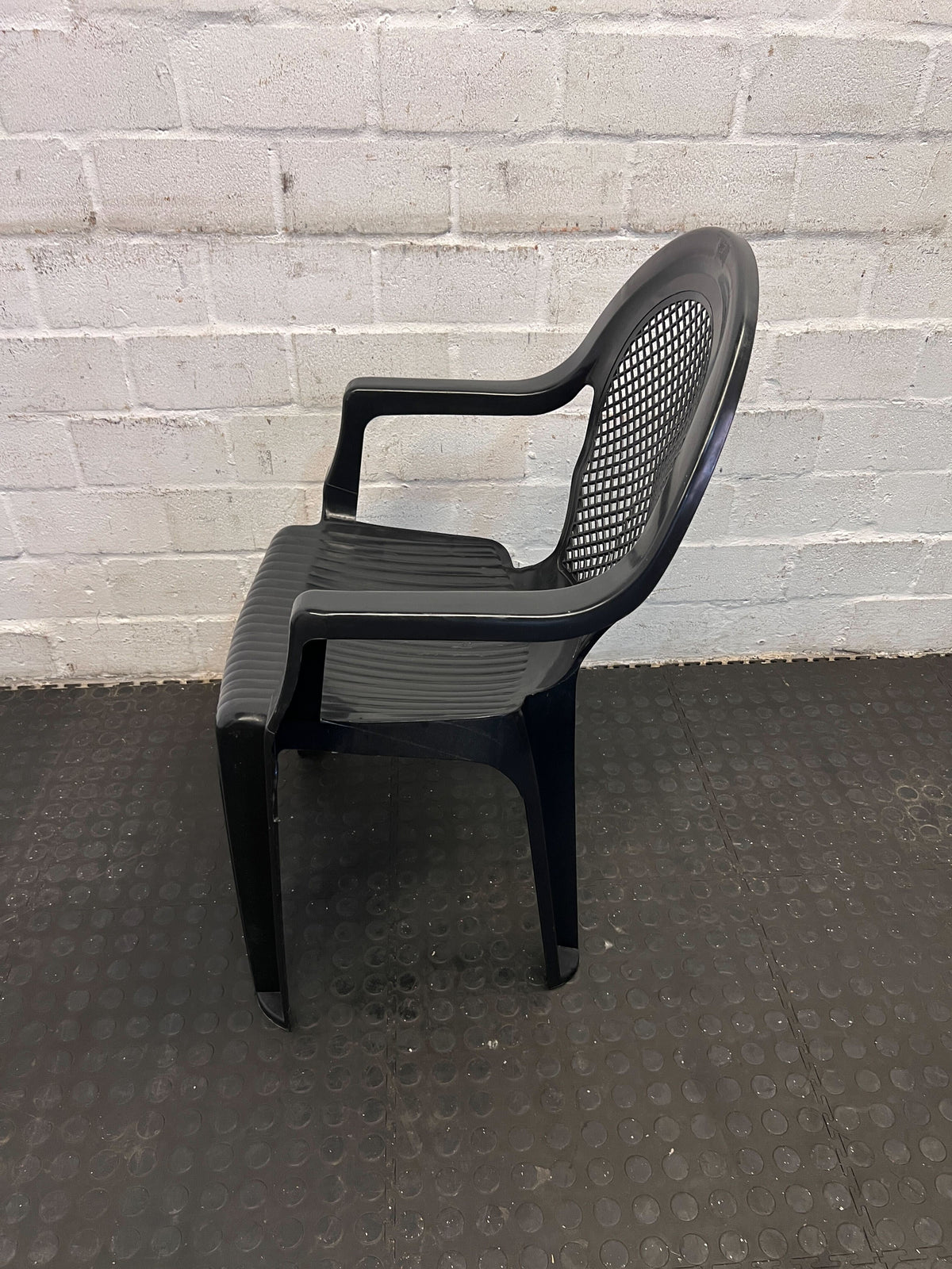 Sturdy Black Plastic Chair with Armrests – Durable & Easy to Clean